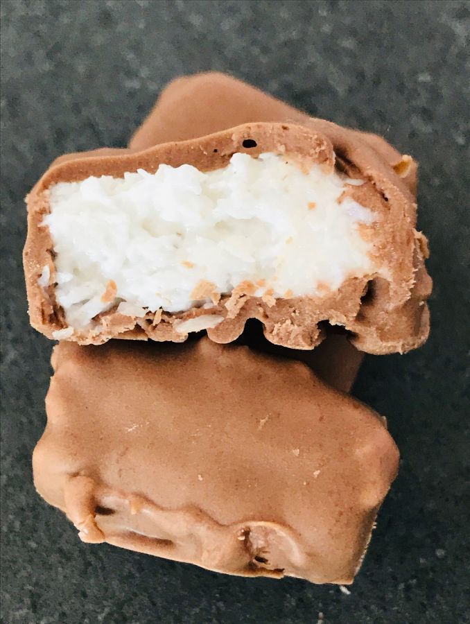 cut in half coconut bar covered in chocolate