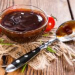 Honey bbq sauce in bowl on table