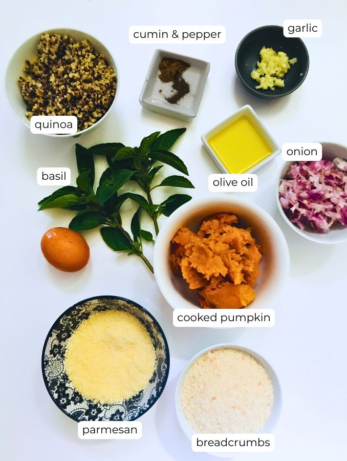 ingredients for pumpkin quinoa patties in bowls on a white background