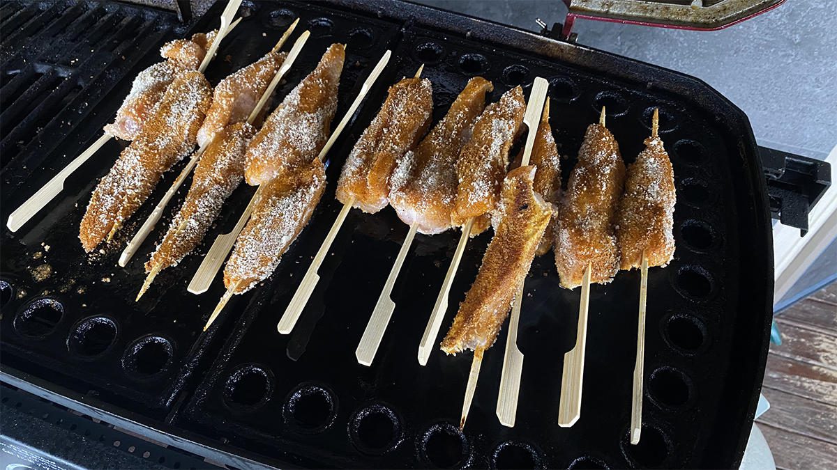 cooking satay chicken sticks on bbq